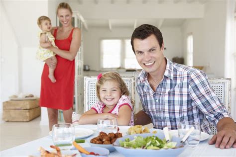 Family enjoying a meal of fresh fruits and vegetables